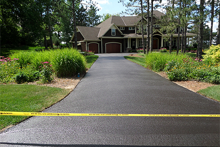 Finished asphalt driveway after seal coating